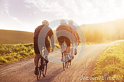 Cyclists riding into the sunset in Tuscany Editorial Stock Photo