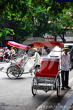 A cyclo driver is working on March 2, 2012 in Ho Chi Minh City, Vietnam. Cyclos have been around for more than a century, but they Editorial Stock Photo