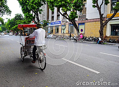 A cyclo driver is working on March 2, 2012 in Ho Chi Minh City, Vietnam. Cyclos have been around for more than a century, but they Editorial Stock Photo