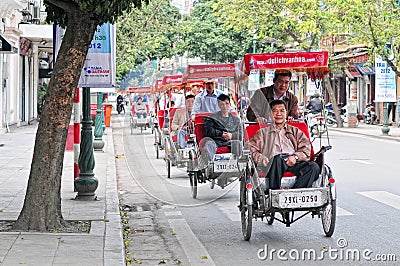 Cyclos carry tourists on street at Old Town in Hanoi, Vietnam Editorial Stock Photo