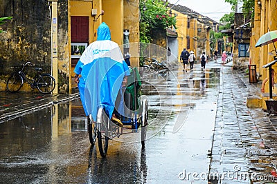 Cyclos run on street in Hoi An, Vietnam Editorial Stock Photo