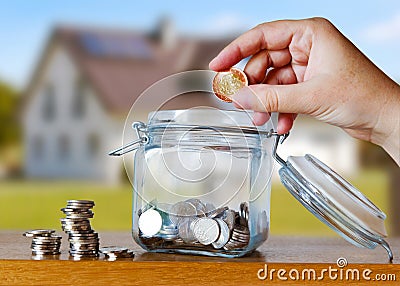 Czech crown coins in a glass moneybox - savings for house cost or mortgage installment Stock Photo