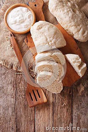 Czech cuisine: sliced boiled knedliks close-up on chopping board Stock Photo