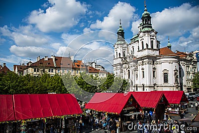 Czech Republic Prague 11.04.2014: People on market in front of saint nikolaus church Editorial Stock Photo