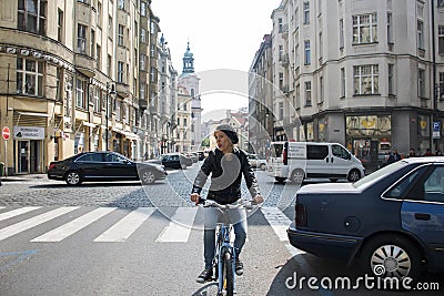 Czech Republic Prague 11.04.2014: Young girl cycling in the capitol city female chilling on a sunny day Editorial Stock Photo