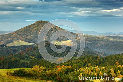 Czech typical autumn landscape. Hills and villages, fall forest. Morning fall valley of Bohemian Switzerland park. Hills with fog, Stock Photo