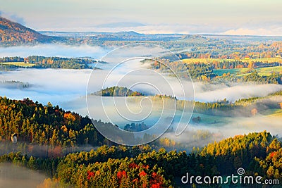 Czech typical autumn landscape. Hills and villages with foggy morning. Morning fall valley of Bohemian Switzerland park. Hills wit Stock Photo