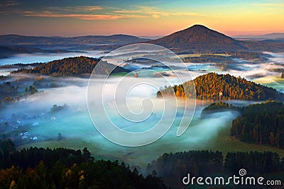 Czech typical autumn landscape. Hills and villages with foggy morning. Morning fall valley of Bohemian Switzerland park. Hills wit Stock Photo