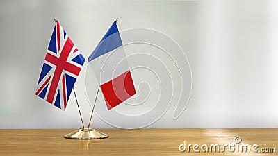 British and French flag pair on a desk over defocused background Stock Photo