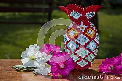 3D origami colorful vase with flowers on the table Stock Photo