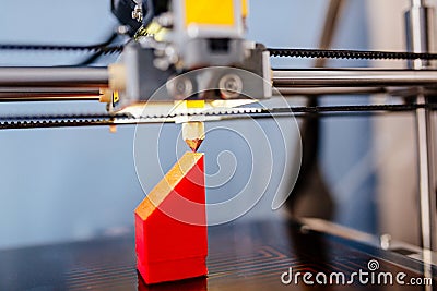 3d printer printing red plastic component Stock Photo