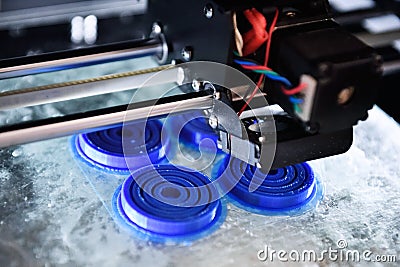 The 3D printer prints the details of the blue plastic. Stock Photo