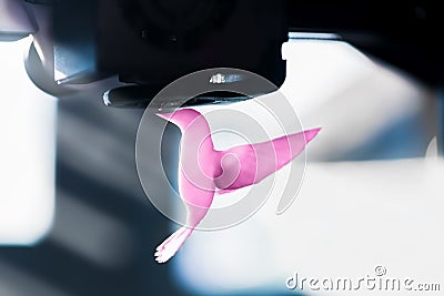 The 3D printer prints pink plastic model of hummingbird Stock Photo