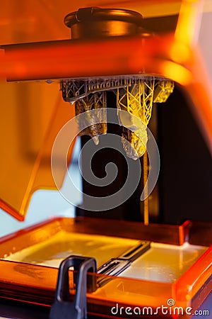 3D printing process. 3D printer for SLA stereolithography printing using photopolymer resin. Stock Photo