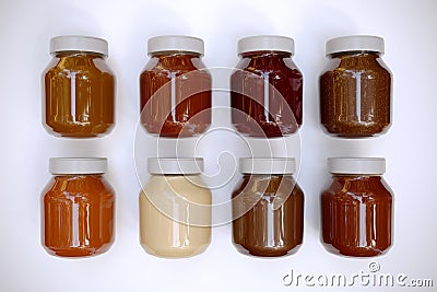 3d render- Close view of chocolate, chocolate nuts, Chocolate white, Honey, Caramel, Apricot, Strawberry in jar isolated on white Stock Photo