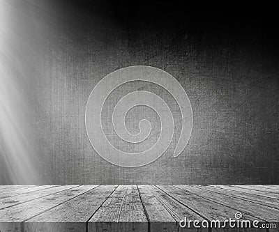 3D wooden table against grunge wall with light shining from the Stock Photo