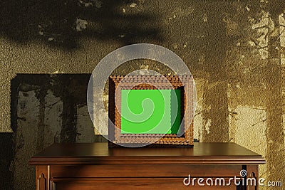 aged picture frame with green screen standing on wooden commode Stock Photo