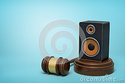 3d rendering of audio loudspeaker on round wooden block and brown wooden gavel on blue background Stock Photo