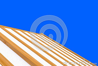 3d rendering. incomplete building new roof wood house construction work with clipping path isolated on blue background. Stock Photo