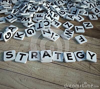 Strategy in letter tiles on wood Stock Photo