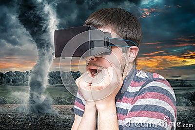 3D simulation concept. Man is wearing virtual reality headset and scared from tornado and storm Stock Photo