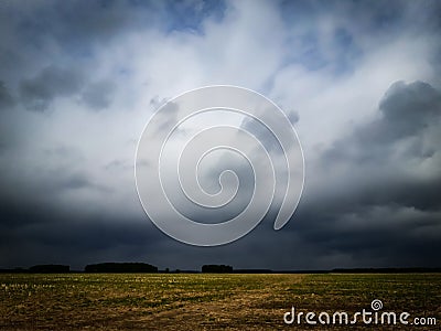 Dark Sky Clouds in the field Stock Photo