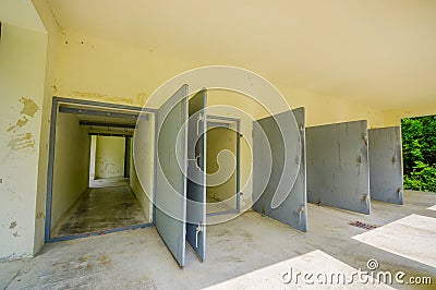 Dachau, Germany - July 30, 2015: Heavy metal doors leading into the krematorium building at concentration camp Editorial Stock Photo