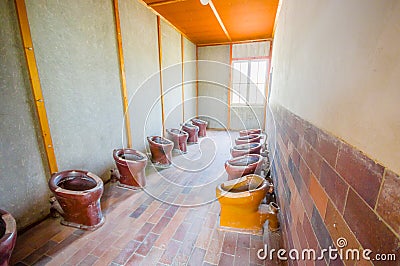 Dachau, Germany - July 30, 2015: Inside bathroom are with many toilets installed in a row for all prisoners to use at Editorial Stock Photo