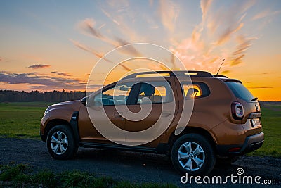 Dacia Duster compact SUV on gravel road at sunset Editorial Stock Photo