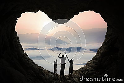 Dad and children inside cave shaped heart Stock Photo