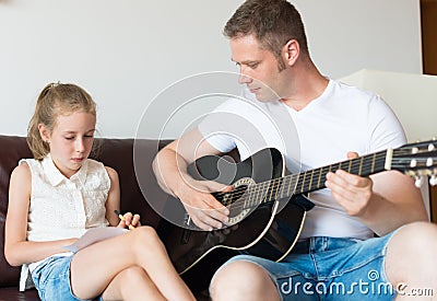 Dad and his daughter compose a song. Stock Photo