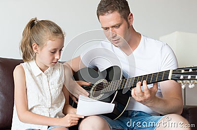 Dad and his daughter compose a song. Stock Photo