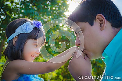 Dad kissing dauther hand Stock Photo