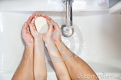 Dad with little daughter thorough washing hands Stock Photo