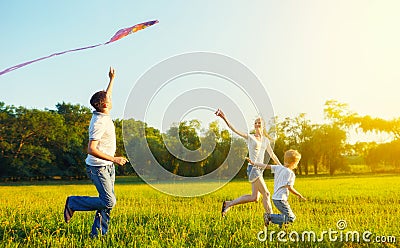 Dad, mom and son child flying a kite in summer nature Stock Photo