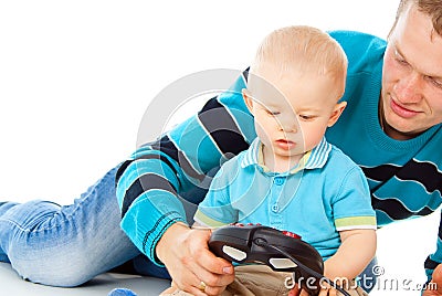 Dad plays with the baby on the joystick Stock Photo