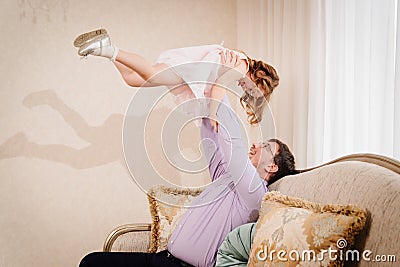 dad plays with his daughter and tosses her up. paternal love. Stock Photo