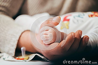 dad`s hand holds the handle of a child. trust and care, childhood and education, support in difficult times. Stock Photo
