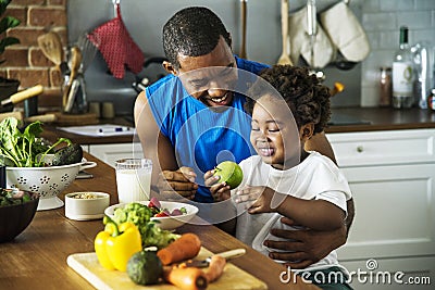 Dad and son cooking together Stock Photo