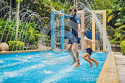 Dad and son have fun in the pool Stock Photo