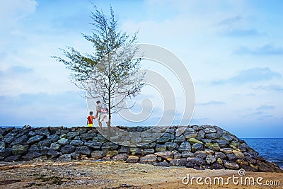 dad and son standing at the sea in the evenin Stock Photo