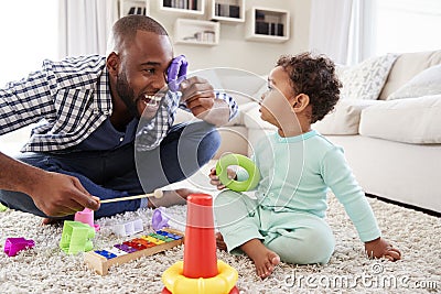 Dad and toddler son having fun playing at home, close up Stock Photo