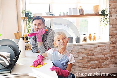 Daddy and daughter enjoying traditional weekend housecleaning Stock Photo