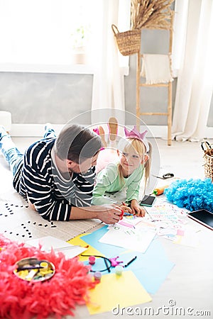 Daddy and girl feeling involved in drawing together Stock Photo