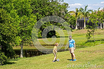 daddy with son improve fatherhood. Outdoor adventures of daddy and son fatherhood together. football family team of Stock Photo