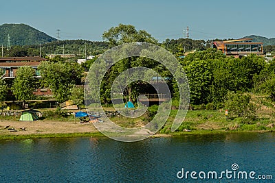 Tents set up on riverbank Editorial Stock Photo