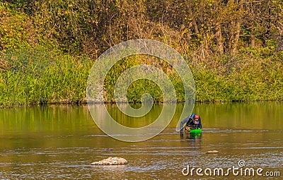 Man with green basket fishing in Kumgang river Editorial Stock Photo