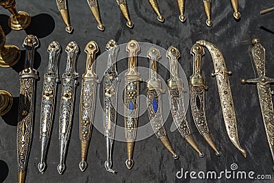 Daggers and knives in steel case in the daytime on the market Stock Photo