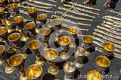 Daggers and knives in a steel case and metal wine cups Stock Photo