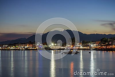 19/11/2018 Dahab, Egypt, incredibly beautiful sunset over a quiet bay in a beautiful spa town with a boat on the foreground Editorial Stock Photo